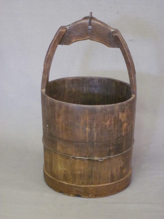 A wooden well bucket with handle