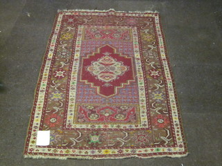 A red ground Persian carpet with central medallion within multi-row borders 65" x 42"