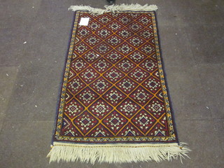 A contemporary Belouch rug with diamond decoration 57" x 33"