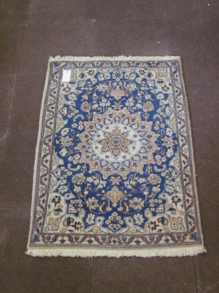 A  blue ground and floral patterned Persian carpet with central medallion 54" x 35"