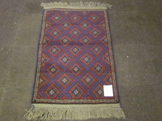 A red and blue ground Belouch rug with diamond field 52" x  33"