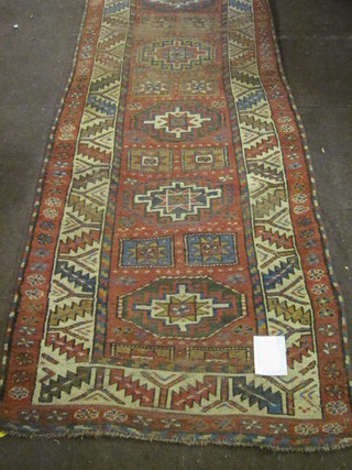 A Caucasian runner with 8 octagons, heavily worn, 42" x 34"
