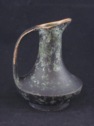 A verdigris terracotta jug, the base incised 42 6"