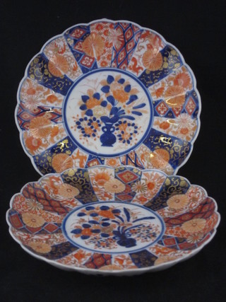 A pair of Japanese Imari circular porcelain plates with lobed bodies and panel decoration 8 1/2"