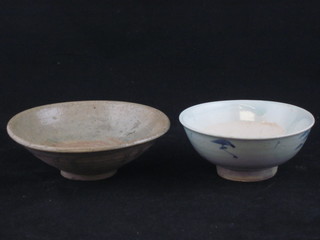An Oriental circular blue and white glazed porcelain bowl 5 1/2" and a natural glazed bowl 5"