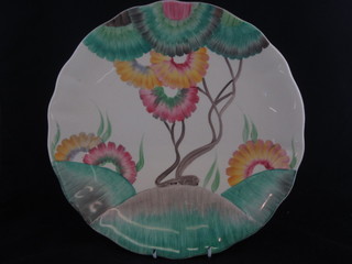 A Clarice Cliff circular charger with floral decoration, the  reverse marked Clarice Cliff, some crazing, 12"