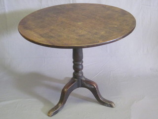 A 19th Century mahogany snap top tea table, raised on turned  column and tripod base, 33"