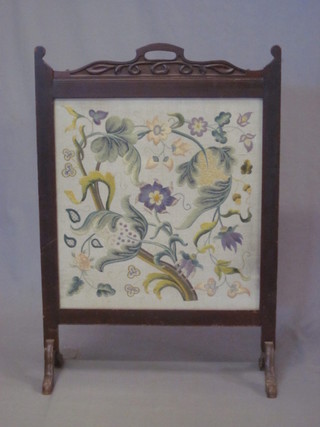An Edwardian Art Nouveau mahogany fire screen with floral  wool work panel to the centre 26"