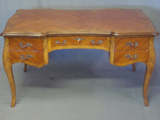 A Kingwood bureau plat of serpentine outline, fitted 1 long and 4 short drawers, raised on cabriole supports 54"