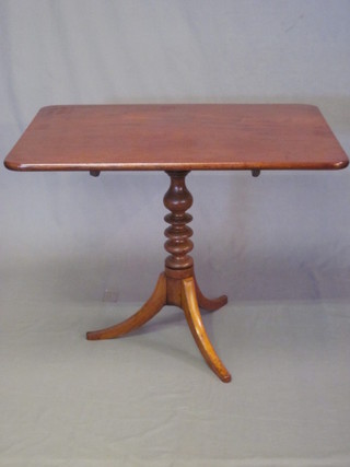 A 19th Century rectangular mahogany snap top tea table, raised  on a column turned and tripod base, 35"