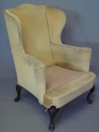 A Queen Anne style mahogany winged armchair with upholstered  seat and back, raised on cabriole supports