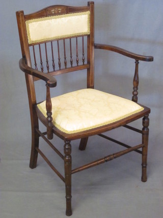 An Edwardian inlaid mahogany open arm chair with bobbin  turned decoration, upholstered seat and back, raised on turned  supports