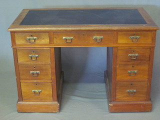 An Edwardian Art Nouveau mahogany kneehole pedestal desk  with inset writing surface above 1 long and 8 short drawers 44"