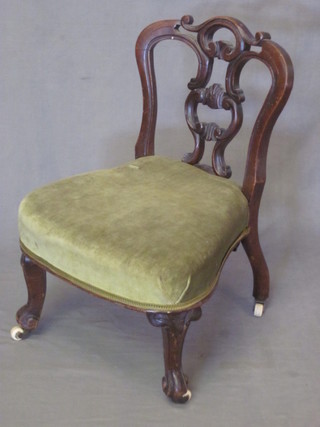 A Victorian walnut slat back nursing chair with upholstered seat, raised on cabriole supports