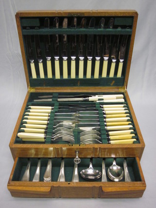 A canteen of silver plated Old English and feather pattern flatware contained in an oak canteen box