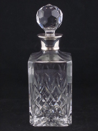 A modern cut glass decanter and stopper with silver collar