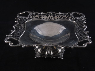 A square pierced silver bowl raised on a spreading foot, Sheffield  1913, 13 ozs