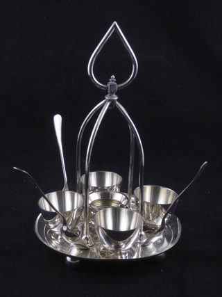 A 4 piece silver plated egg cruet and a salt in the form of a  Cauldron