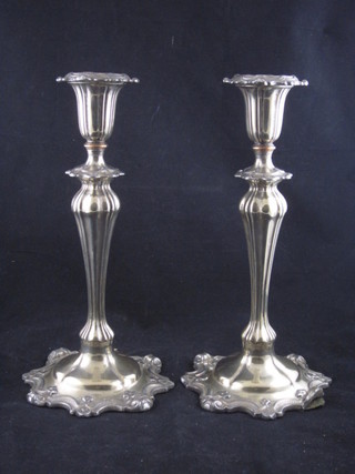 A pair of Rococo style silver plated candlesticks with detachable  sconces 10"