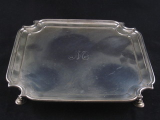 A square silver salver with bracketed border, raised on hoof feet London 1916 24 ozs