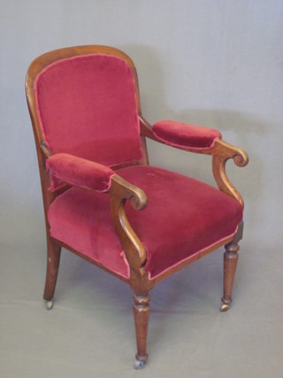 A William IV mahogany show frame open arm chair, raised on  turned supports upholstered in red material