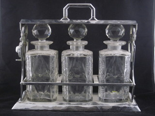 A silver plated and cut glass 3 bottle tantalus