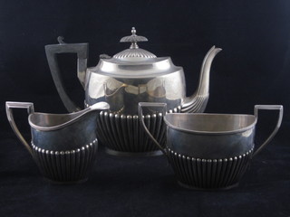 A 3 piece silver plated tea service of oval form and demi-reeded decoration by Walker & Hall, comprising teapot, twin handled  sugar bowl and cream jug