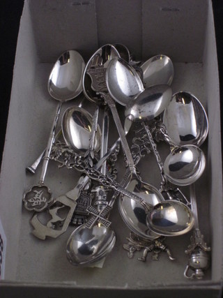 A collection of various silver souvenir teaspoons