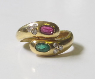 An 18ct yellow gold dress ring in the form of 2 entwined  serpents, the head set a ruby and emerald