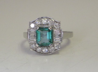 An 18ct white gold dress ring set an emerald supported by  diamonds, approx 0.80/1.43ct