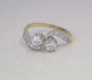 An 18ct yellow gold cross-over dress ring set 2 diamonds, approx 0.90ct