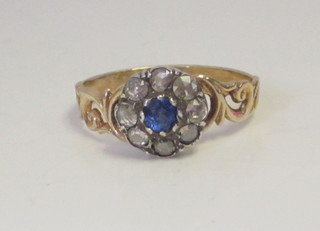 An 18ct yellow gold dress ring set a sapphire surrounded by diamonds
