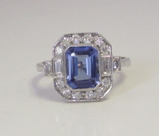 An 18ct white gold dress ring set a tanzanite supported by  diamonds, approx 0.50/1.80ct
