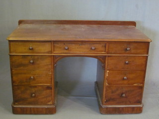A Victorian mahogany kneehole pedestal desk with raised back, fitted 1 long and 8 short drawers 51"