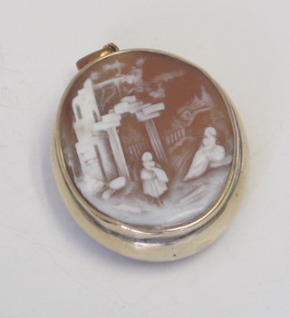 A shell carved pendant contained in a gilt metal mount, the reverse set a hardstone