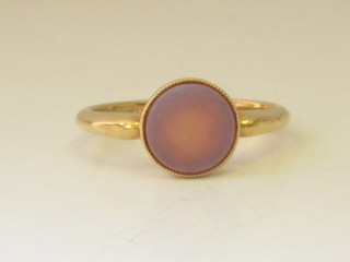 A lady's 18ct gold signet ring set an oval polished stone
