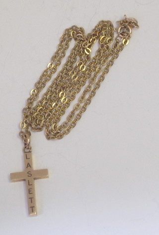 A 9ct gold cross hung on a fine chain