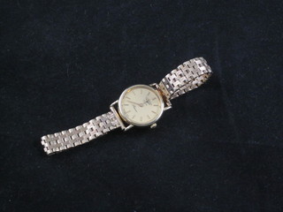 A lady's Longines wristwatch contained in a 9ct gold case with integral bracelet