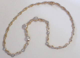 A lady's 14ct gold necklet set numerous clusters of diamonds, approx 4.50ct  ILLUSTRATED