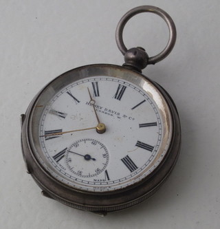 An open faced pocket watch by Henry Davis & Co contained in a Continental silver oval case