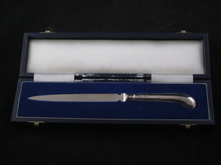 A paper knife with silver pistol grip handle, cased