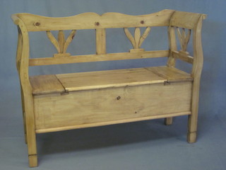 A Continental stripped and polished pine settle with hinged lid  47"