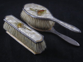 A 4 piece silver backed and plastic dressing table set comprising  a pair of hairbrushes and a pair of clothes brushes, Birmingham  1928