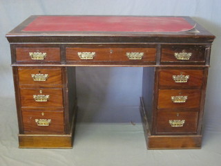 A Victorian mahogany kneehole pedestal desk with inset red  writing surface above 1 long and 8 short drawers 48"