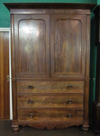 A William IV mahogany linen press, the interior fitted 2 shallow  trays enclosed by panelled doors, the base fitted 3 long drawers  raised on bun feet 55"