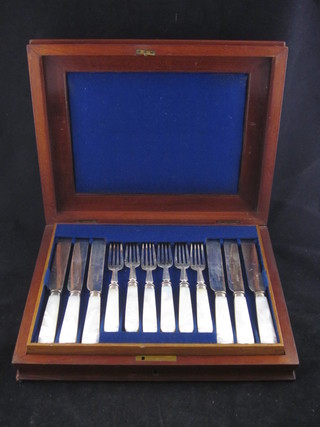 A set of 23 cake knives and forks with mother of pearl handles,  1 fork missing, 1 knife f, contained in a mahogany canteen box