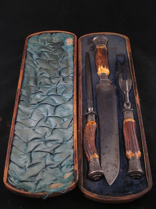 A Victorian steel 3 piece carving set comprising knife, fork and  steel with staghorn handles