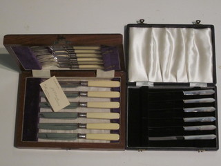 A set of 6 silver plated fish knives and forks contained in an oak canteen box and 6 table knives, cased
