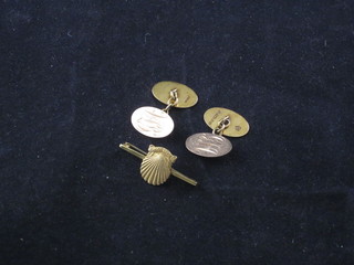 A pair of 15ct oval gold cufflinks together with a gold bar brooch decorated a Shell, for 10 years service to Shell Oil