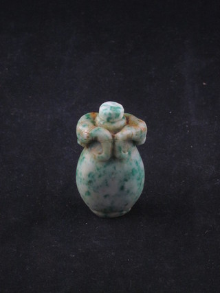 An Oriental carved green hardstone snuff bottle 2"